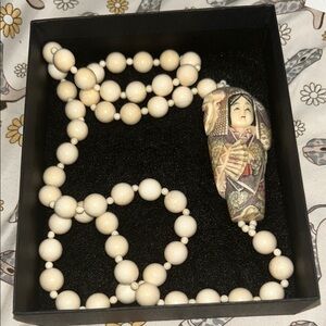 Handcrafted Beaded Necklace with Figurine Pendant